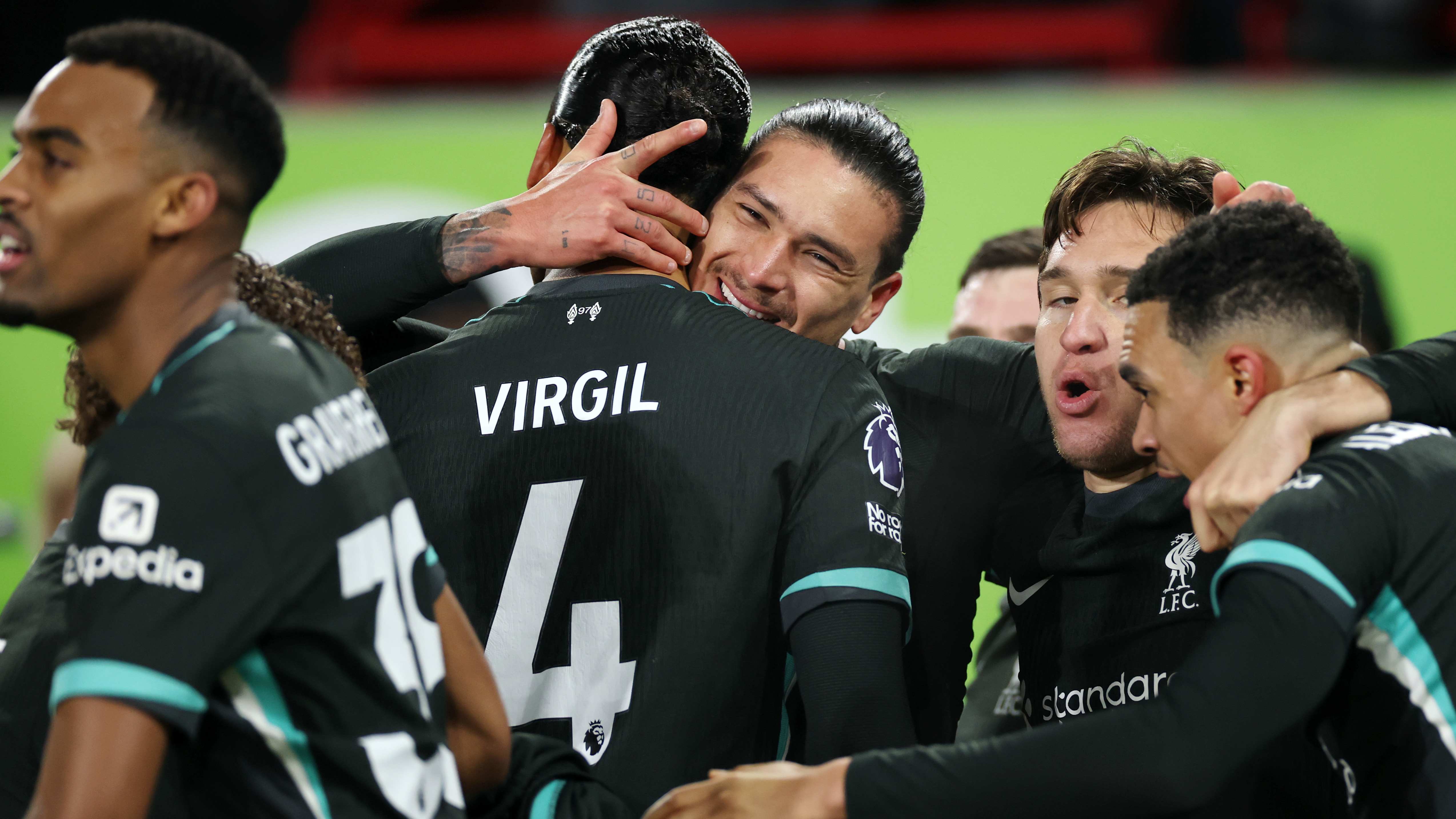 Darwin Nunez (centre) celebrates his winning goal at Brentford with Virgil van Dijk and his other Liverpool teammates