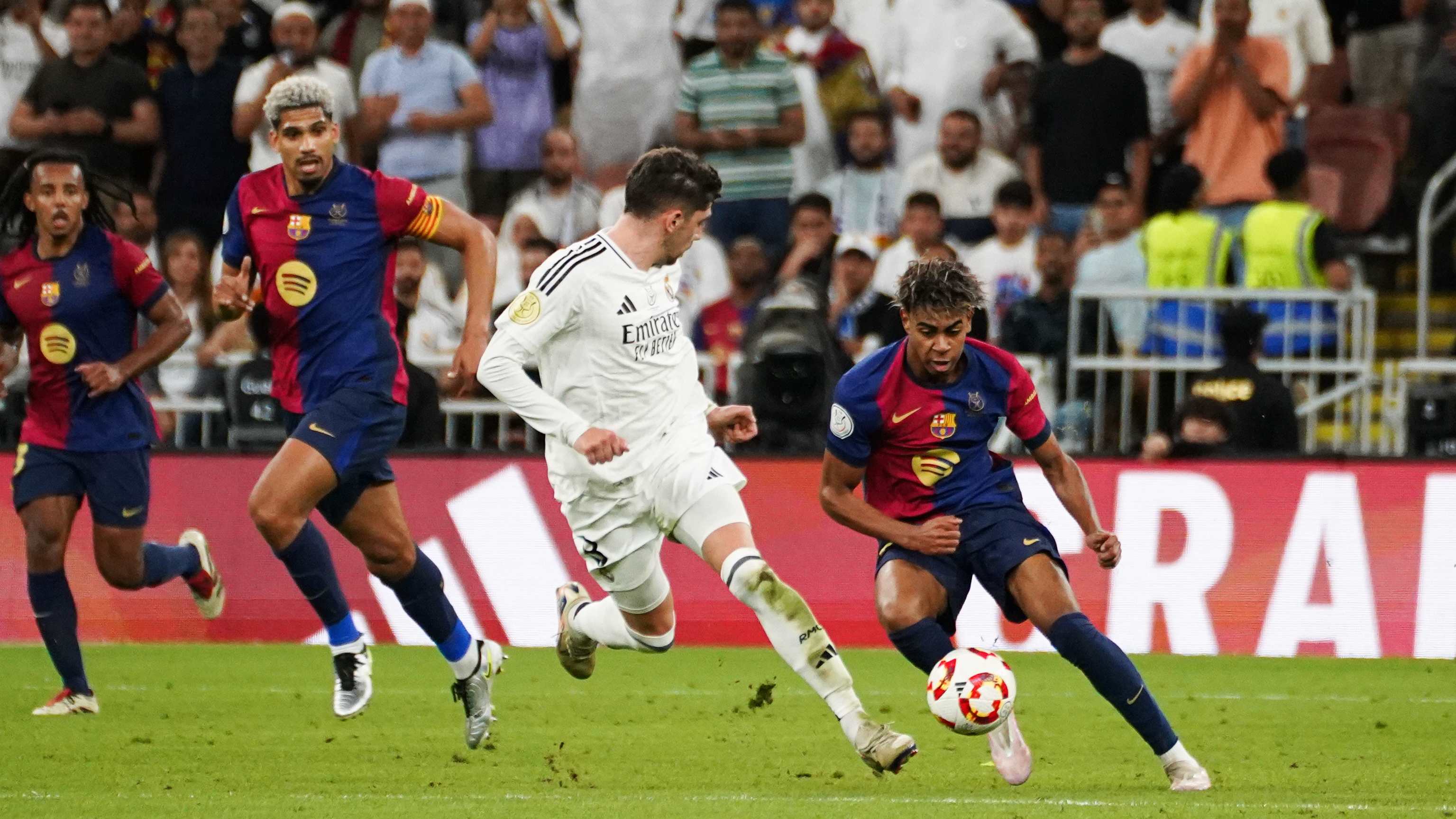 Barcelona's Spanish player Lamine Yamal (R) seen in action...